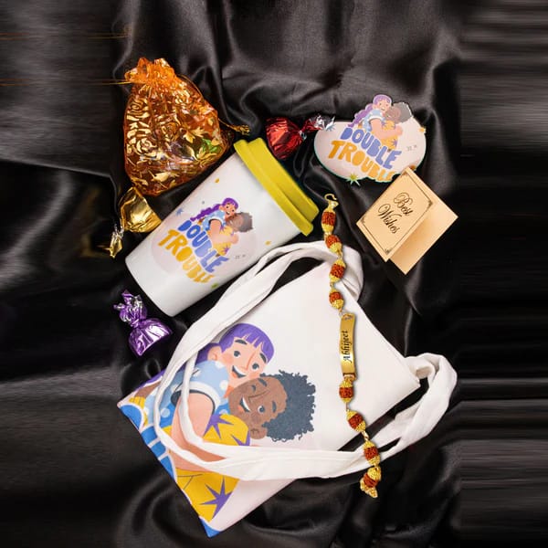 Double Trouble Rakhi hamper  Includes Rudraksha Rakhi,Ceramic Tumbler,Tote Bag,Fridge Magnet,Chocolate Pouch & Best wishes Card a personal touch to the gift hamper.